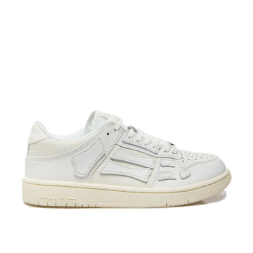 A pair of white low-top calfskin sneakers by AMIRI, available at Lestyle Boutique. These premium sneakers feature a perforated round toe, padded ankle, logo detailing, and a durable flat rubber sole for comfort and style.