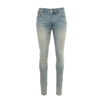 A pair of stretch stonewashed denim jeans by AMIRI, available at Lestyle Boutique. These jeans feature distressed details, a logo label at the back, belt loops, and a concealed button closure for a modern, rugged look.