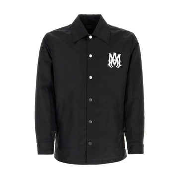 A sleek and lightweight black jacket by AMIRI, available at Lestyle Boutique. The jacket showcases embroidered logo details on both the chest and back, made from durable 100% nylon for a timeless look.