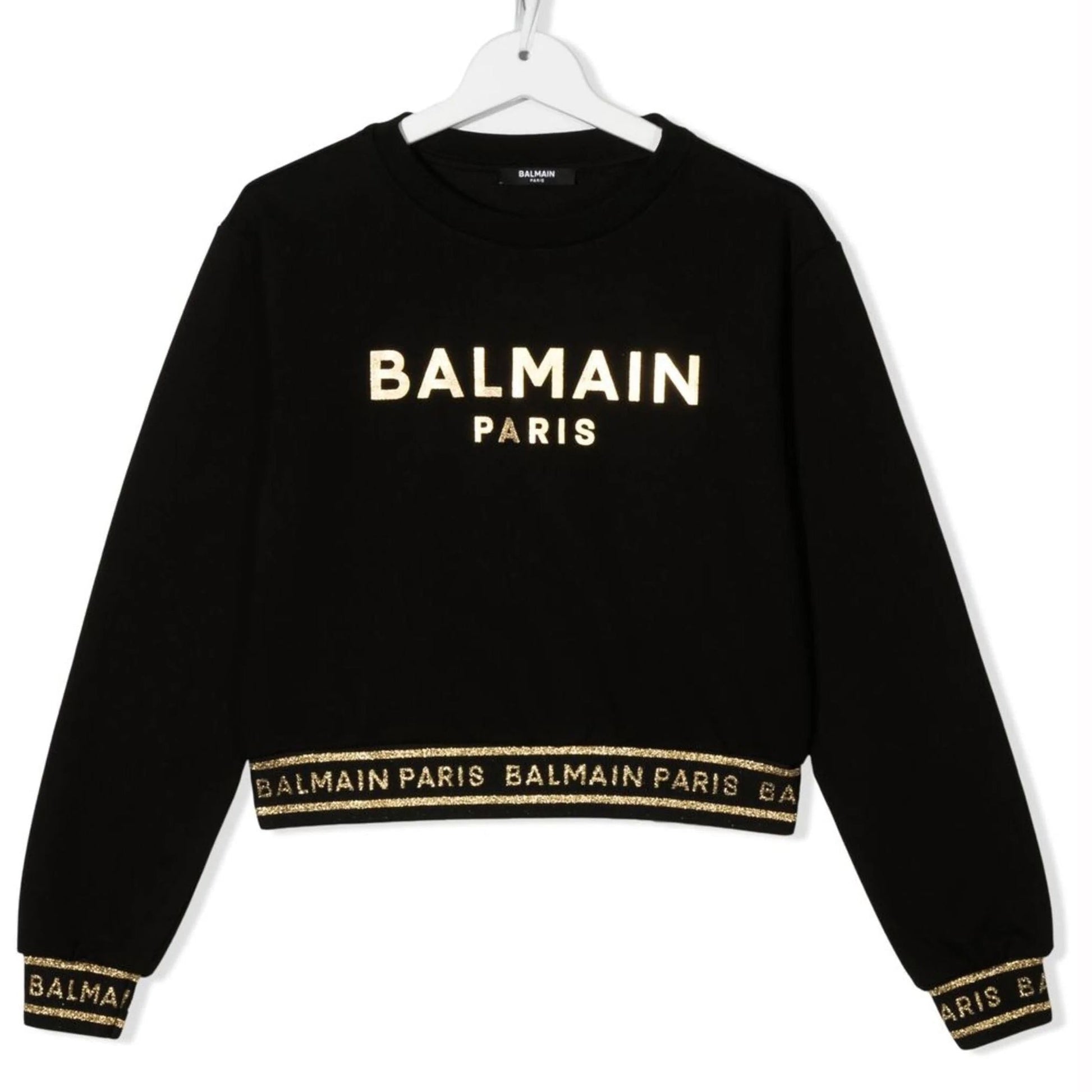 Balmain kids sweatshirt in black featuring a metallic logo print and stylish design elements. This premium piece showcases a classic crew neck and long sleeves, perfect for a trendy yet comfortable look. The high-quality craftsmanship is evident in the luxurious fabric and attention to detail, making it an ideal choice for young fashionistas. Perfect for casual outings or stylish playdates, available at Lestyle Boutique Melbourne.