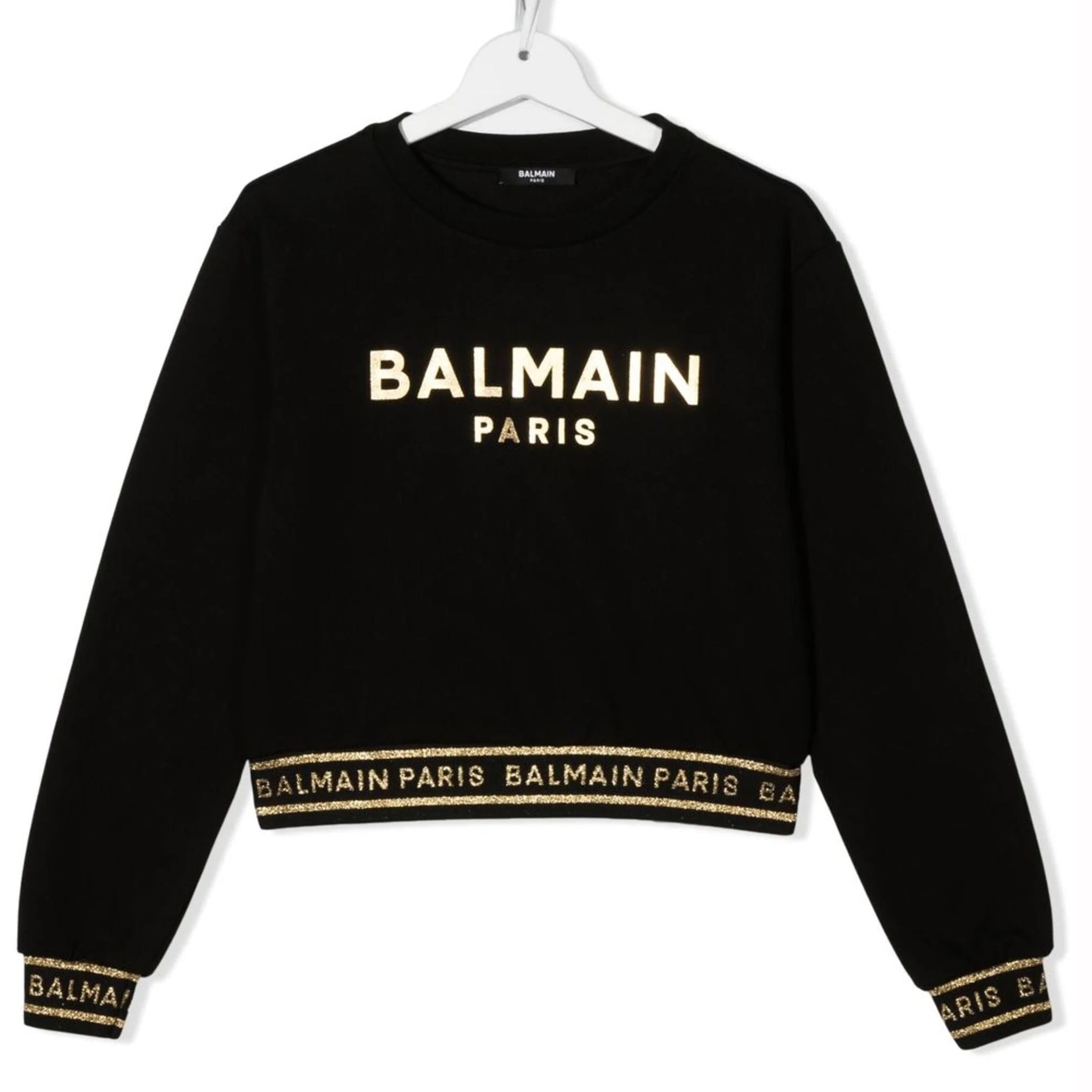 Balmain kids sweatshirt in black featuring a metallic logo print and stylish design elements. This premium piece showcases a classic crew neck and long sleeves, perfect for a trendy yet comfortable look. The high-quality craftsmanship is evident in the luxurious fabric and attention to detail, making it an ideal choice for young fashionistas. Perfect for casual outings or stylish playdates, available at Lestyle Boutique Melbourne.