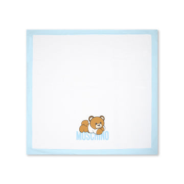 Moschino Kids cotton blanket in white with a blue border featuring a teddy bear print, available at Lestyle Boutique Melbourne.
