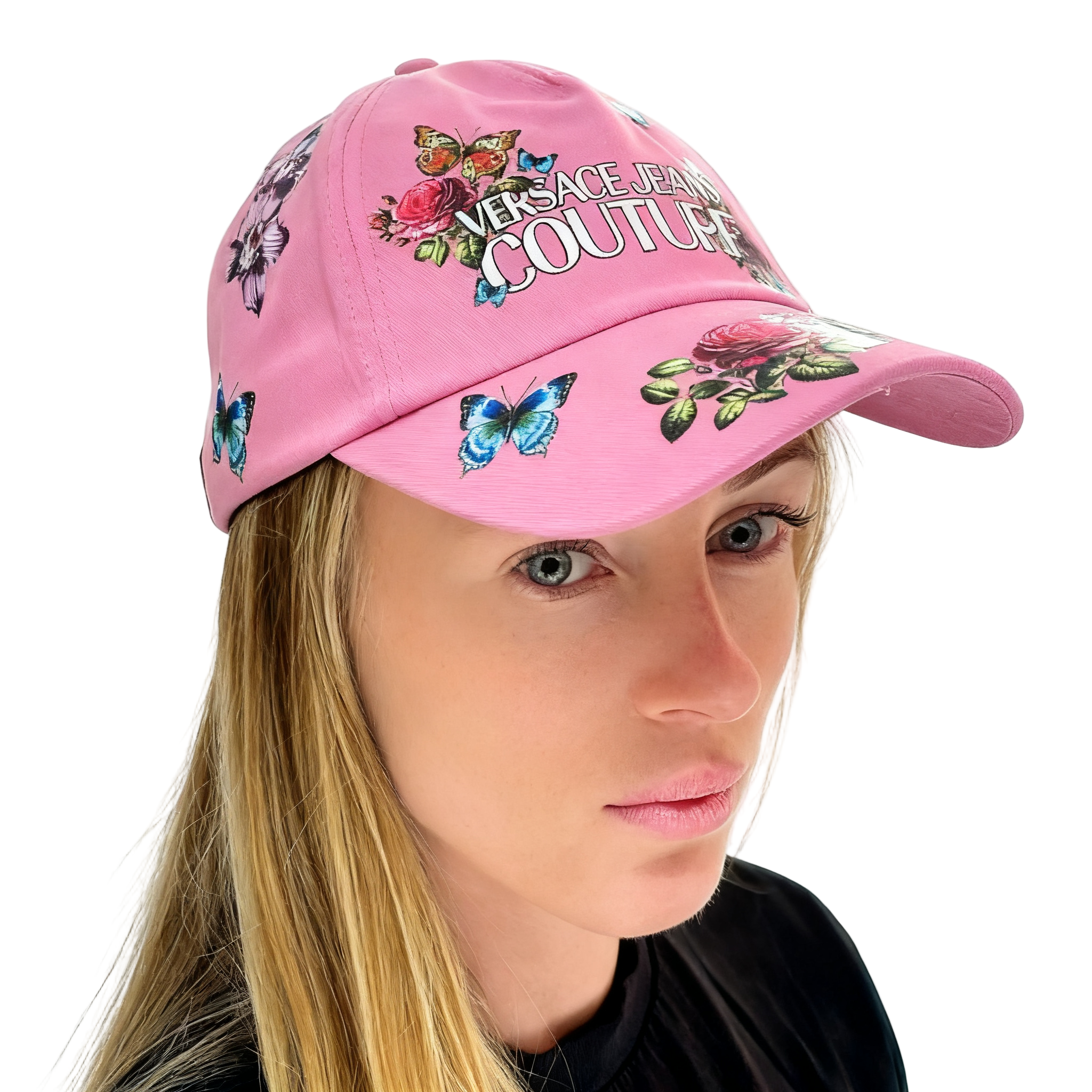Pink Versace cap with floral and butterfly designs worn by a model on a white background