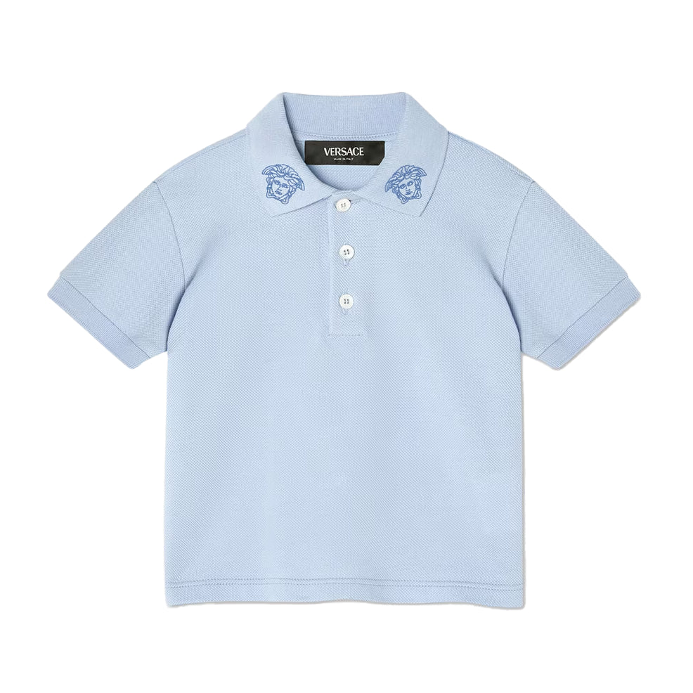 The Versace Embroidered Medusa Baby Polo Shirt from Lestyle Boutique in a charming light blue colour featuring the iconic Medusa Kids embroidery on the collar, short sleeves, a pointed collar, and a three-button placket.