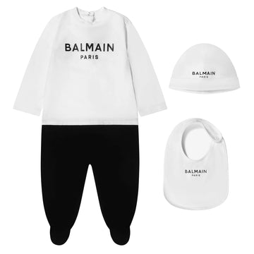 Balmain kids cotton baby grow set featuring a stylish white long-sleeve top with the iconic Balmain logo and comfortable black pants. This premium designer outfit is crafted from high-quality cotton, ensuring softness against the skin. The set includes a matching bib and hat, making it perfect for fashionable infants. Ideal for casual outings or special occasions, this luxury piece combines comfort and style for your little one, available at Lestyle Boutique Melbourne.