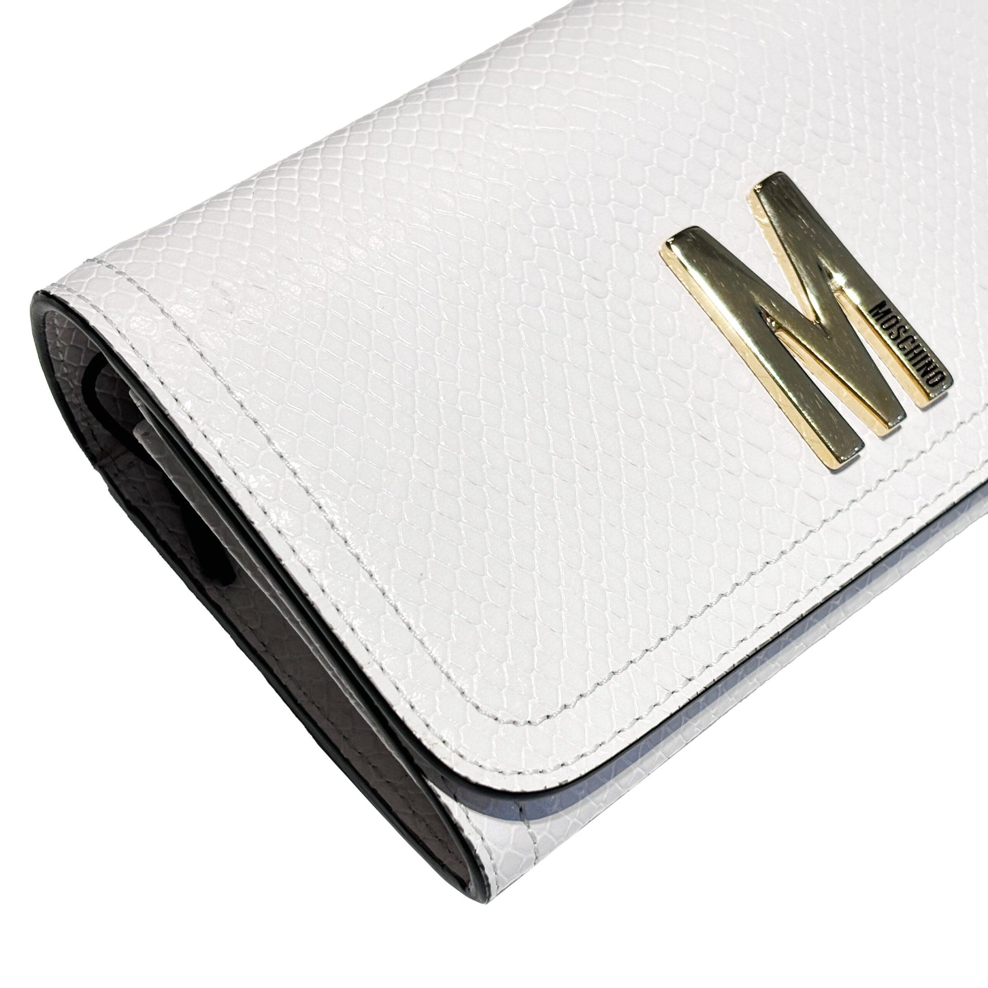 Moschino white textured leather clutch bag with gold "M" logo plaque, available at Lestyle Boutique Melbourne. A stylish and sophisticated choice for formal occasions.