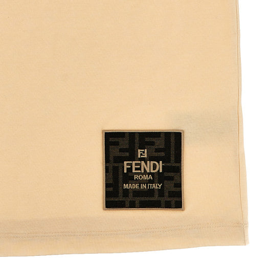 Fendi Kids beige t-shirt with a signature FF logo patch on the lower front, offering a sophisticated touch for young fashion enthusiasts, available at Lestyle Boutique Melbourne.