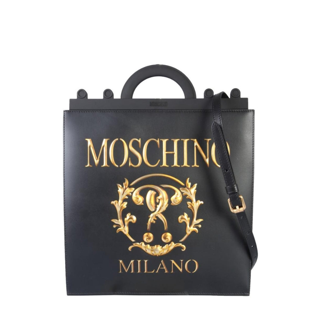 Moschino black leather square tote bag featuring a large gold Double Question Mark logo print, top handles, and a detachable shoulder strap, Made in Italy, available at Lestyle Boutique 136 Little Collins St.