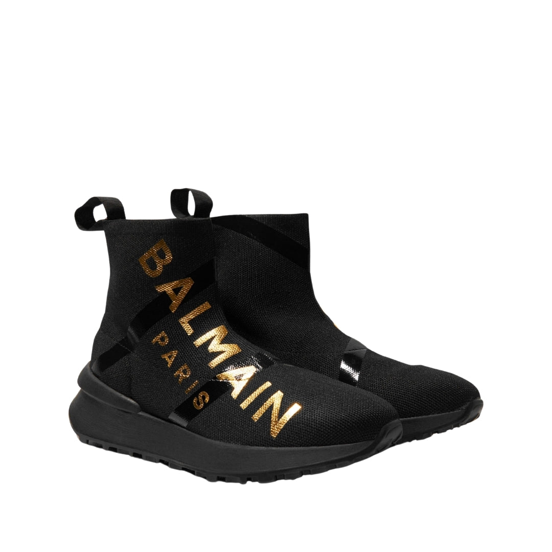 Balmain Kids black sock speed trainers featuring a large gold Balmain Paris logo print and chunky black sole, Made in Italy, available at Lestyle Boutique 136 Little Collins St.