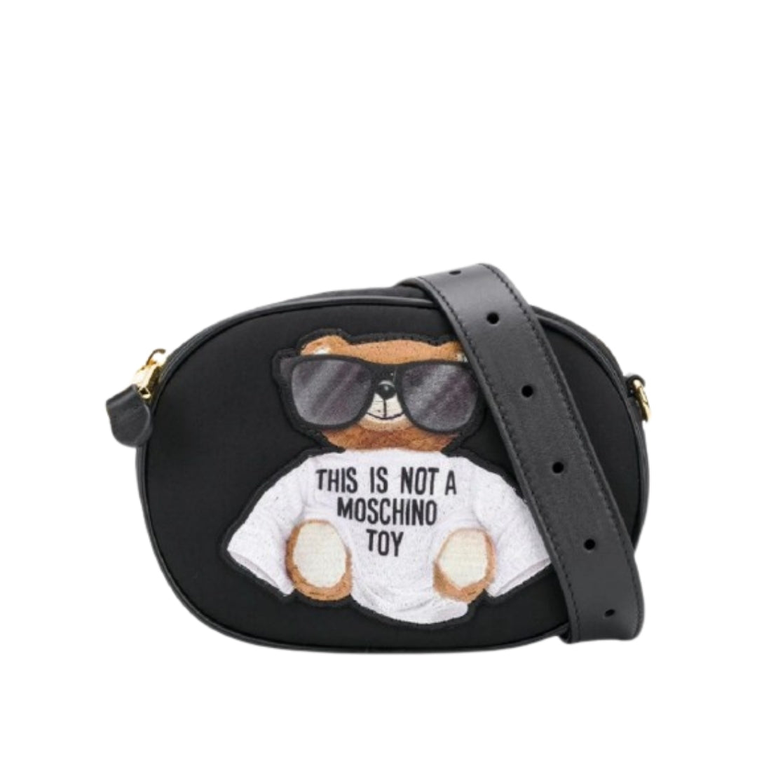 Moschino black belt bag featuring the 'This Is Not A Moschino Toy' Teddy Bear appliqué, top zip closure with gold-tone hardware, and an adjustable black strap, available at Lestyle Boutique 136 Little Collins St.