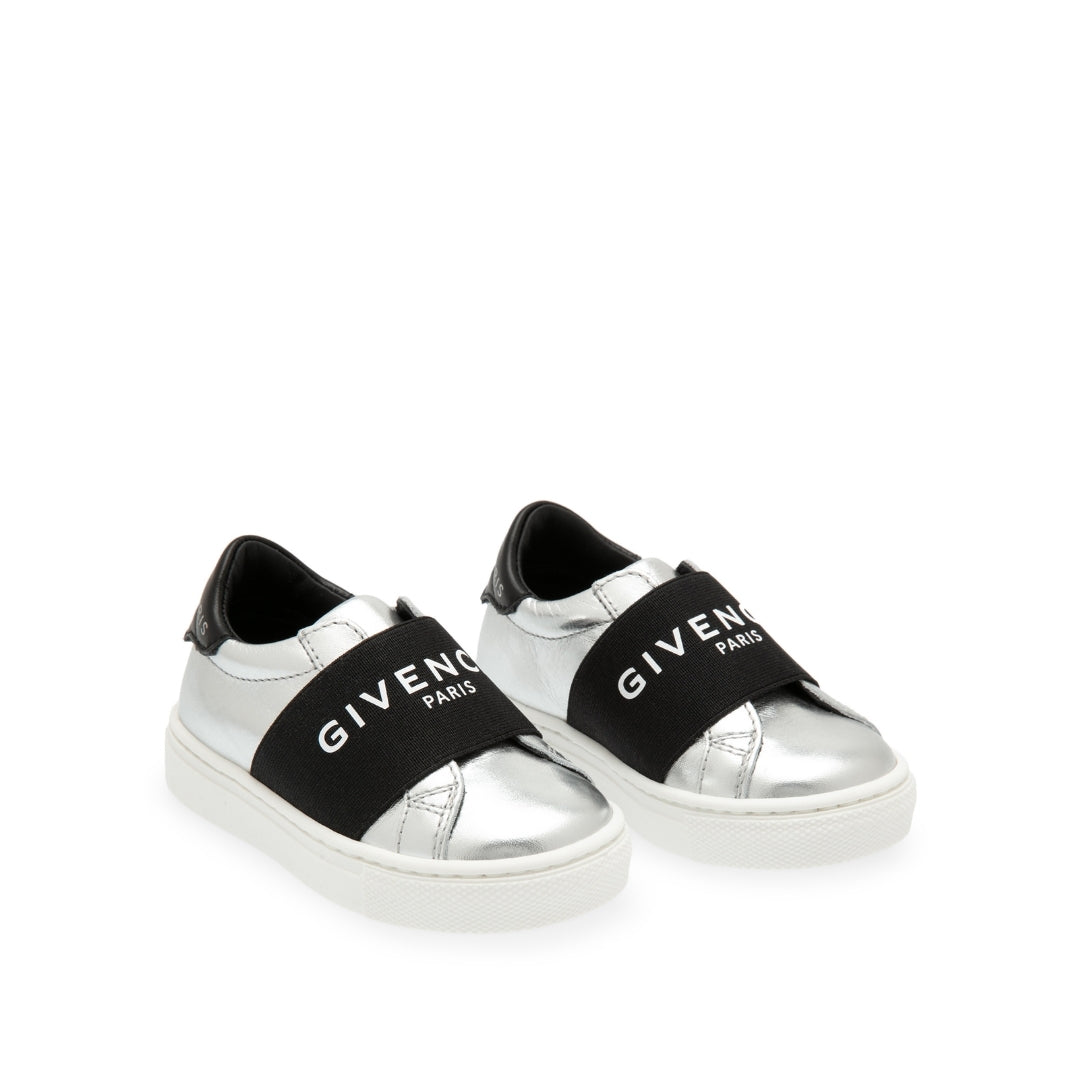 Givenchy Kids silver leather slip-on sneakers with a black elastic logo strap, black heel tab, and white rubber sole, Made in Italy, available at Lestyle Boutique 136 Little Collins St.