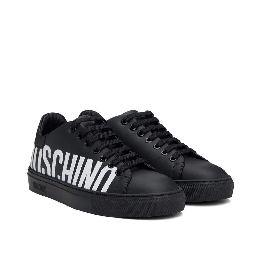 Moschino men's black leather low-top sneakers with lace-up fastening and a large contrast white logo print along the side, available at Lestyle Boutique 136 Little Collins St.