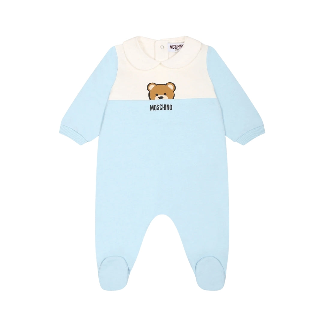 Moschino Kids Baby light blue organic cotton footed babygrow featuring a color-block design with white/cream chest panel, Peter Pan collar, long sleeves, snap closure, and Teddy Bear print, available at Lestyle Boutique 136 Little Collins St.