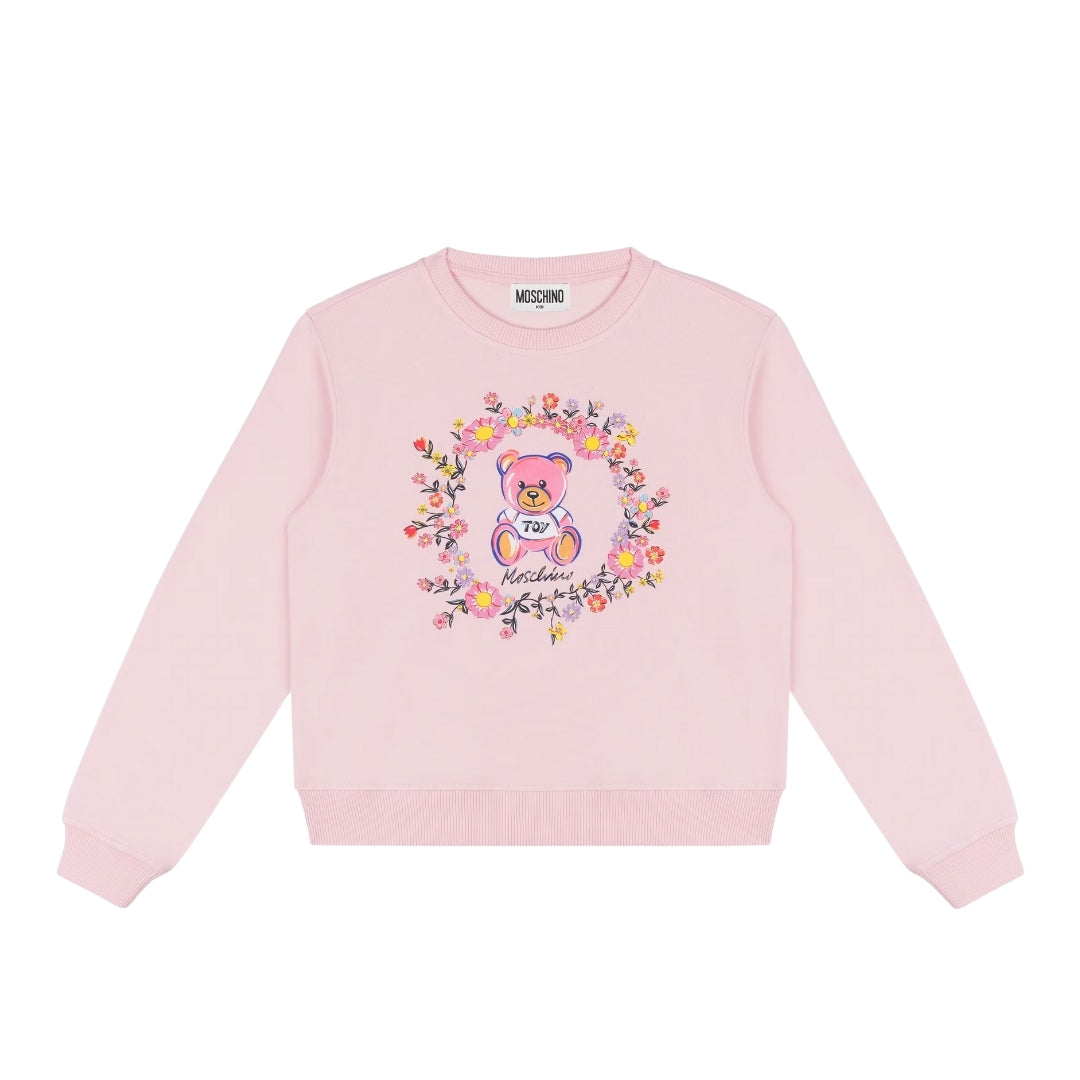 Moschino Kids pink cotton sweatshirt with crew neck and long sleeves, featuring a Teddy Bear print surrounded by a floral wreath on the chest and ribbed trims, available at Lestyle Boutique 136 Little Collins St.