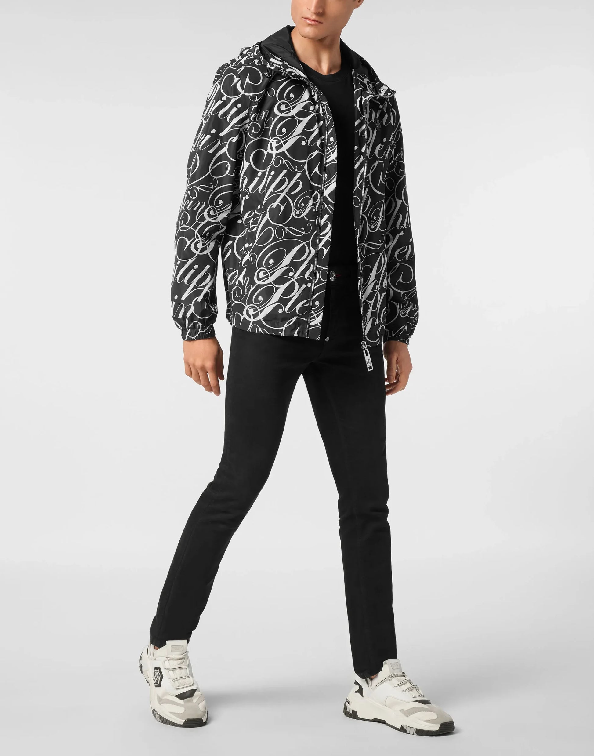 Philipp Plein black and white nylon hooded windbreaker jacket with an all-over script logo print, zip fastener, and elasticated cuffs and bottom hem, available at Lestyle Boutique 136 Little Collins St.