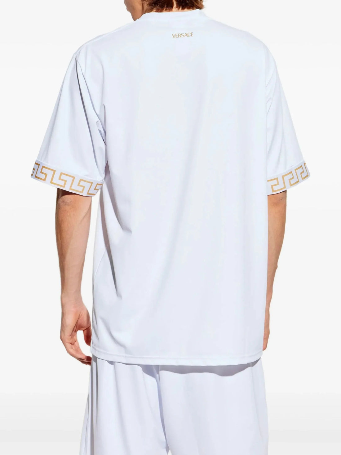 Versace white cotton T-shirt with gold Greca motif on the sleeves, featuring a crew neck, short sleeves, and straight hem, made in Italy, available at Lestyle Boutique 136 Little Collins St.