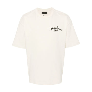 A beige stretch-cotton t-shirt by AMIRI, available at Lestyle Boutique. Featuring embroidered logos on the chest and back, this tee combines comfort and elegance with a resort-inspired aesthetic.