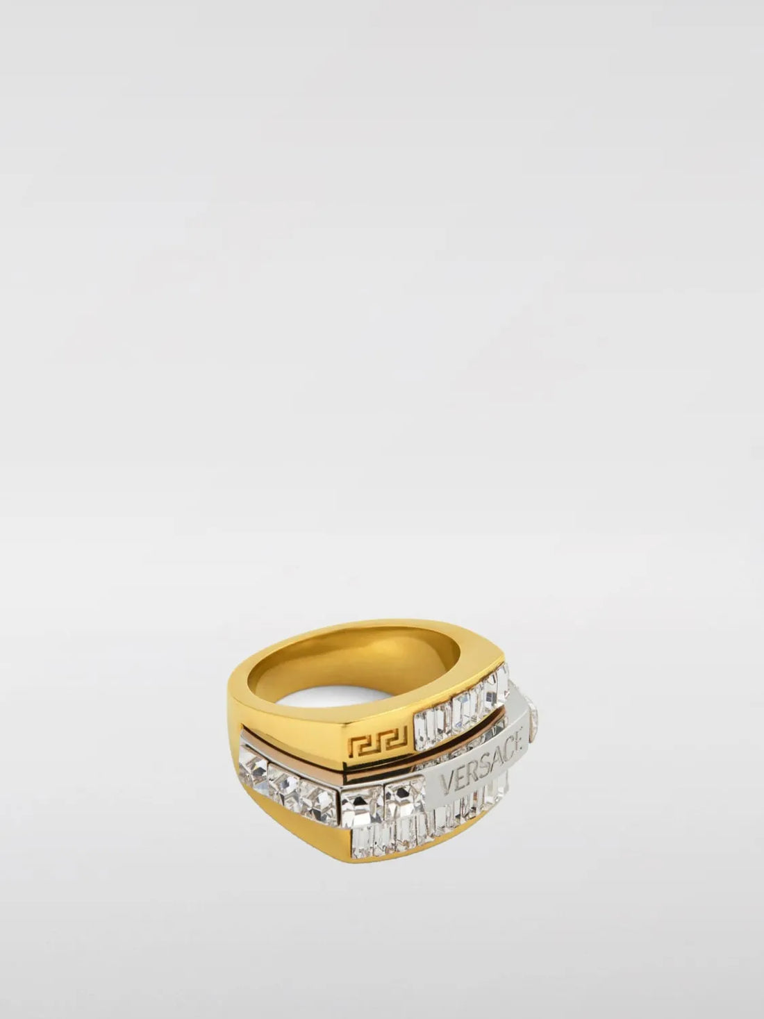 Versace Jewel Men Bandeau Ring, featuring a gold-tone brass structure with rhinestone embellishments and engraved logo, available at Lestyle Boutique.