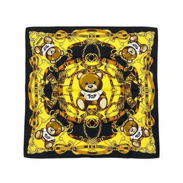 Moschino silk scarf featuring a bold yellow teddy bear and ornate golden chain motif available at Lestyle Boutique Melbourne