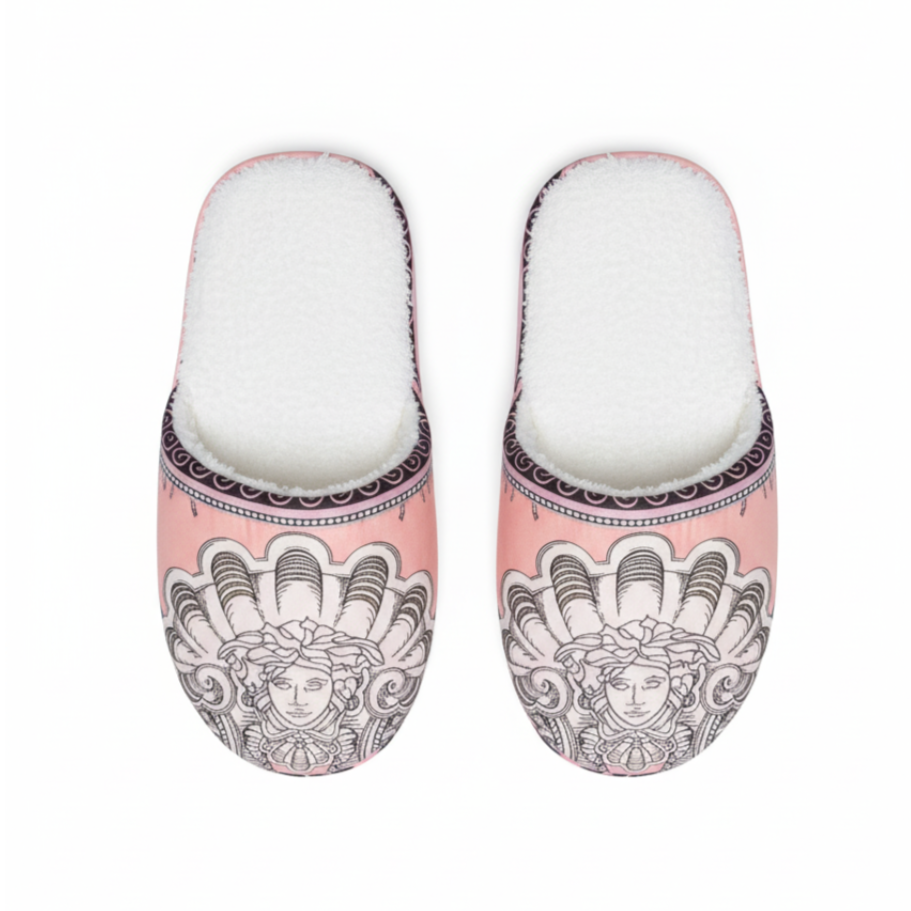 Pair of slippers with decorative design on a white background