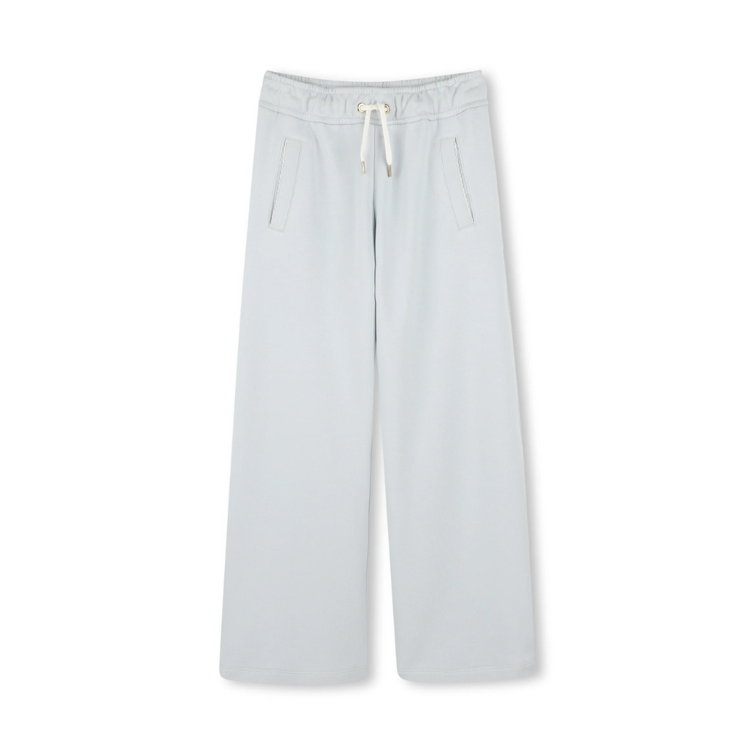 Chloe Kids pants with drawstring waist and two front pockets with slanted openings in light blue delave, available at Lestyle Boutique Melbourne