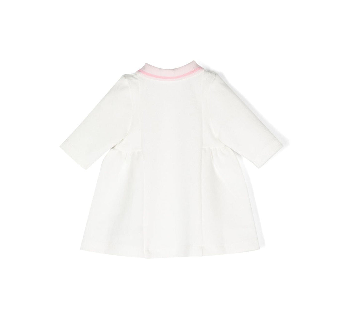 BOSS kidswear dress in off-white with light pink accents, featuring a premium cotton blend for comfort. This stylish dress includes a classic polo collar and long sleeves, perfect for young girls. The embroidered logo adds a designer touch, making it ideal for special occasions or everyday wear. Designed with a concealed front button fastening and a straight hem for a polished look, this dress is a must-have for fashionable kids. Available at Lestyle Boutique Melbourne.
