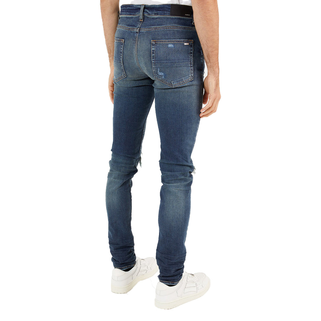 Amiri blue MX1 distressed skinny jeans featuring a unique ripped design and premium denim fabric. These luxury jeans showcase a modern skinny fit with a stylish distressed finish, perfect for a casual yet fashionable look. Ideal for men seeking high-quality designer denim that stands out, available at Lestyle Boutique Melbourne.