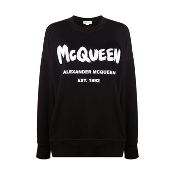 Alexander McQueen black logo-print crew neck sweatshirt featuring the iconic McQueen logo in bold white lettering. This premium designer piece showcases a relaxed fit with long sleeves, perfect for layering or casual wear. The high-quality craftsmanship is evident in the soft fabric and precise stitching, making it a luxurious addition to any wardrobe. Ideal for fashion-forward individuals seeking a statement piece for everyday wear or special occasions, available at Lestyle Boutique Melbourne.