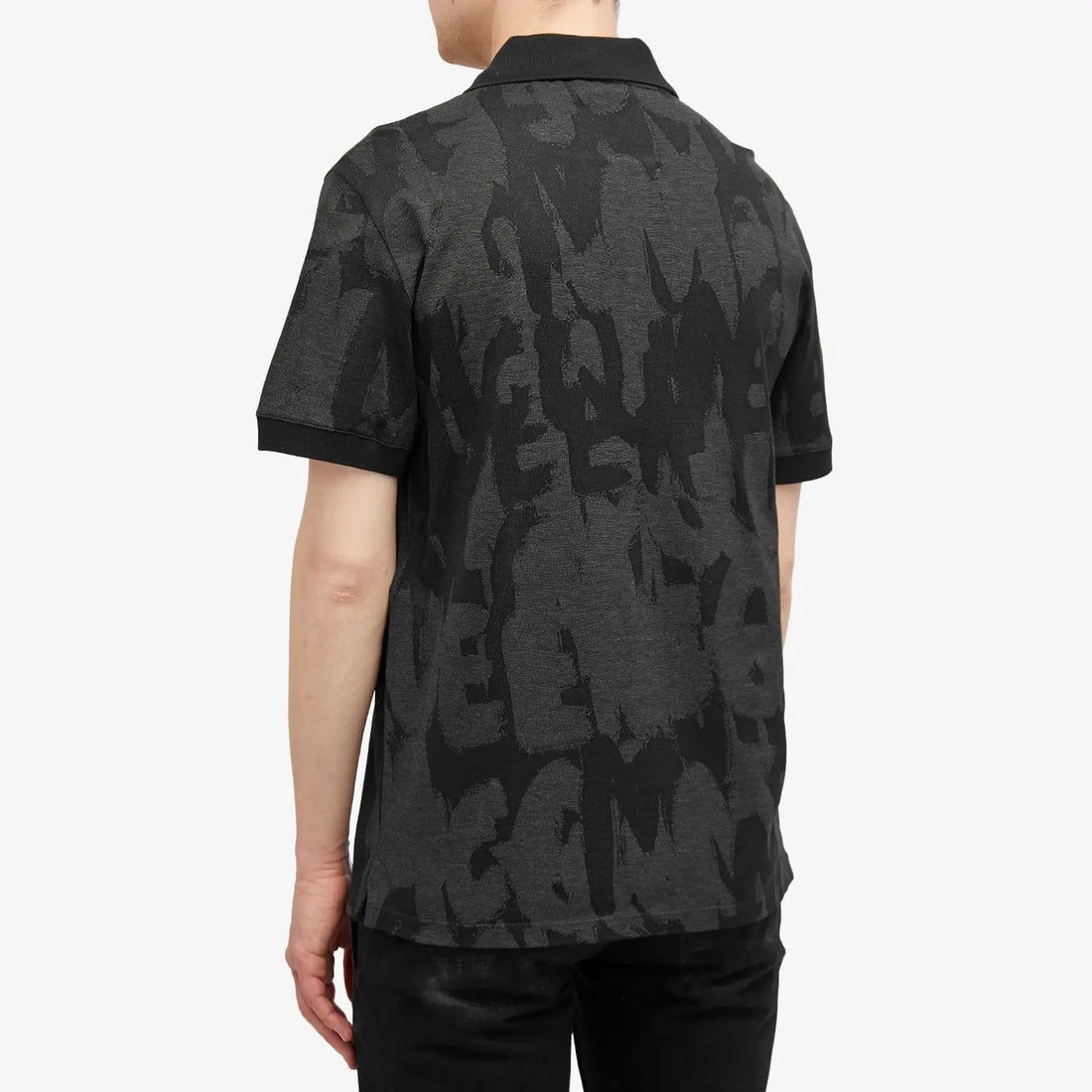 Alexander McQueen Jacquard Graffiti Logo Polo in black and charcoal, available at Lestyle Boutique Melbourne. A stylish and comfortable choice for casual wear.