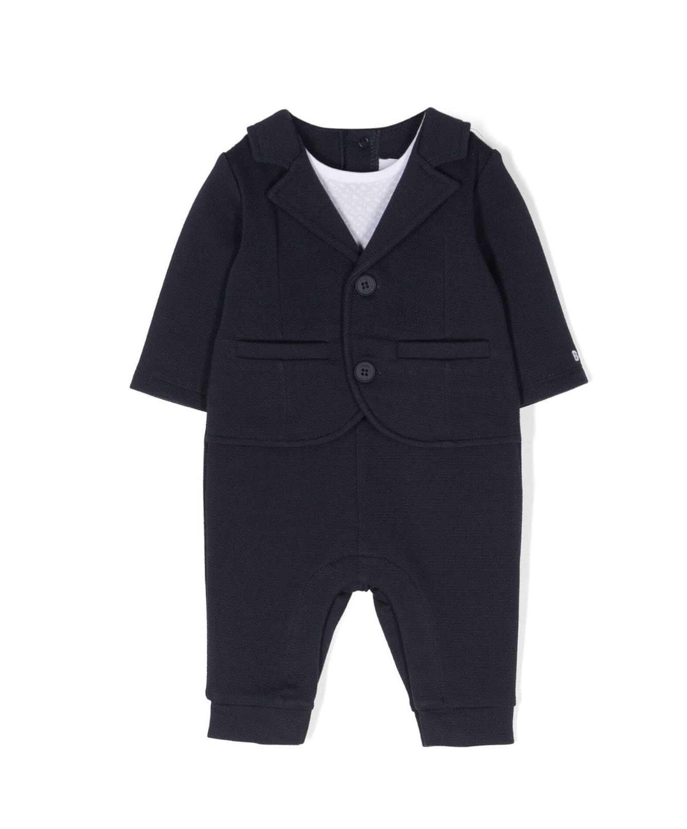 BOSS Kidswear tailored all-in-one suit in classic black, designed for comfort and style. This premium piece features long sleeves, a straight leg, and decorative button detailing, making it perfect for special occasions. The elasticated ankles ensure a snug fit, while the rear press-stud fastening adds convenience. Ideal for your little one’s formal events, this luxury designer outfit combines quality craftsmanship with chic design, available at Lestyle Boutique Melbourne.
