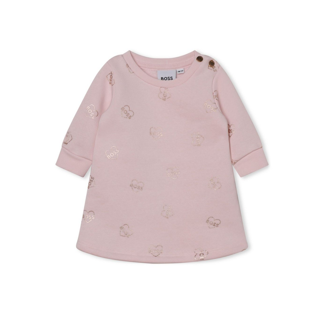 BOSS KIDSWEAR pale pink cotton dress featuring an all-over logo print with a metallic finish. This stylish crew neck design includes long sleeves, ribbed cuffs, and a curved hem, making it perfect for casual outings or special occasions. The heart motif adds a playful touch, while the button fastening at the shoulder ensures easy dressing. Crafted from high-quality organic cotton blend, this dress is both comfortable and fashionable for young girls, available at Lestyle Boutique Melbourne.