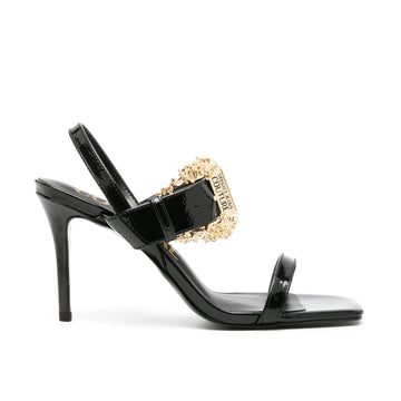 Versace Jeans Couture Emily 95mm Slingback Sandals in black, featuring a Baroque buckle detail and glossy patent finish. Elegant and perfect for evening looks, available at Lestyle Boutique.