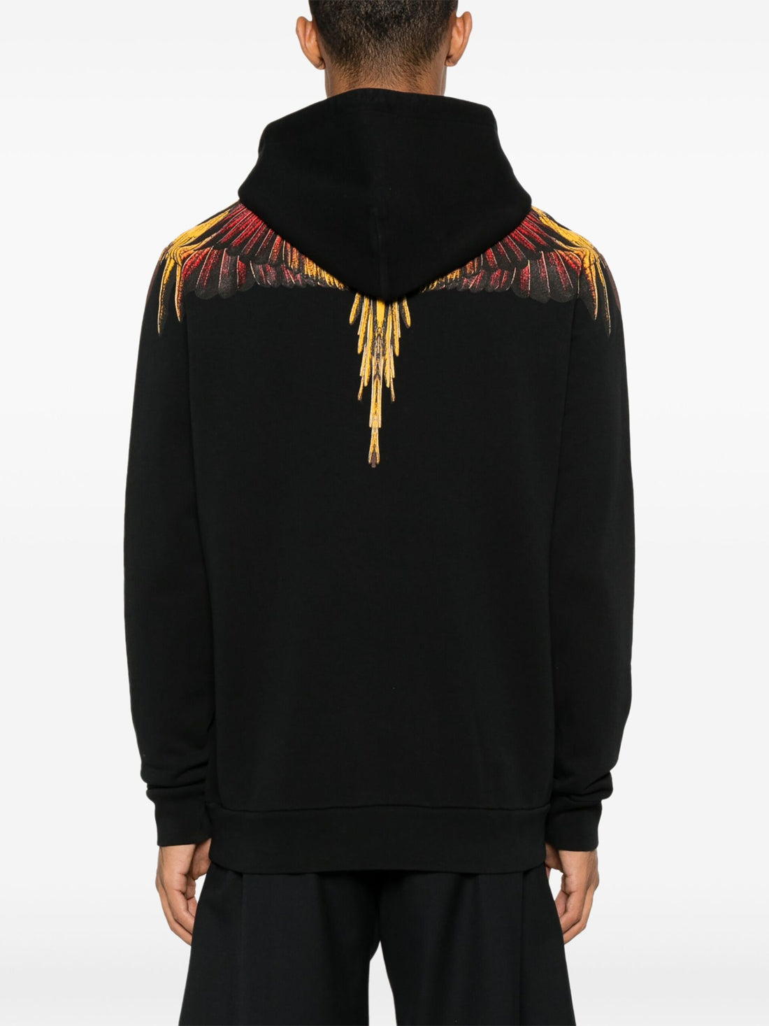 Marcelo Burlon County of Milan hoodie with vibrant yellow and red wings on a black base, crafted from organic cotton, available at Lestyle Boutique.