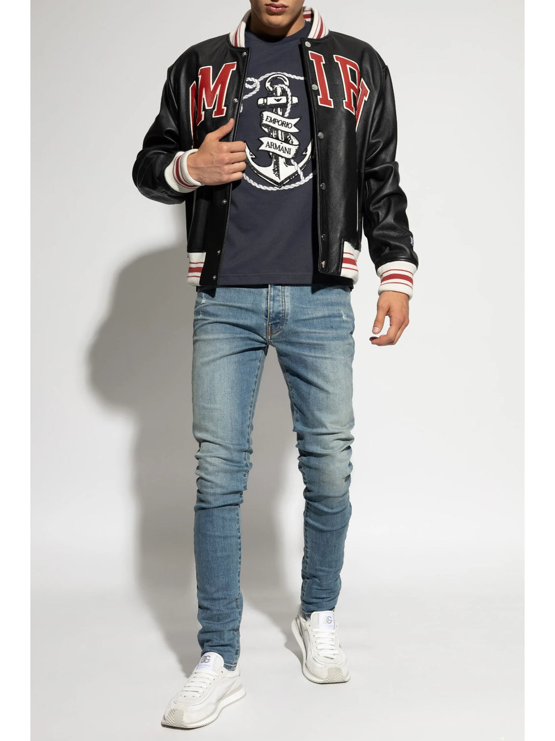 A pair of blue skinny jeans by AMIRI, available at Lestyle Boutique. These low-rise jeans feature a stretch construction, faded detailing, whiskering effects, and a classic five-pocket design for a modern and sleek fit.