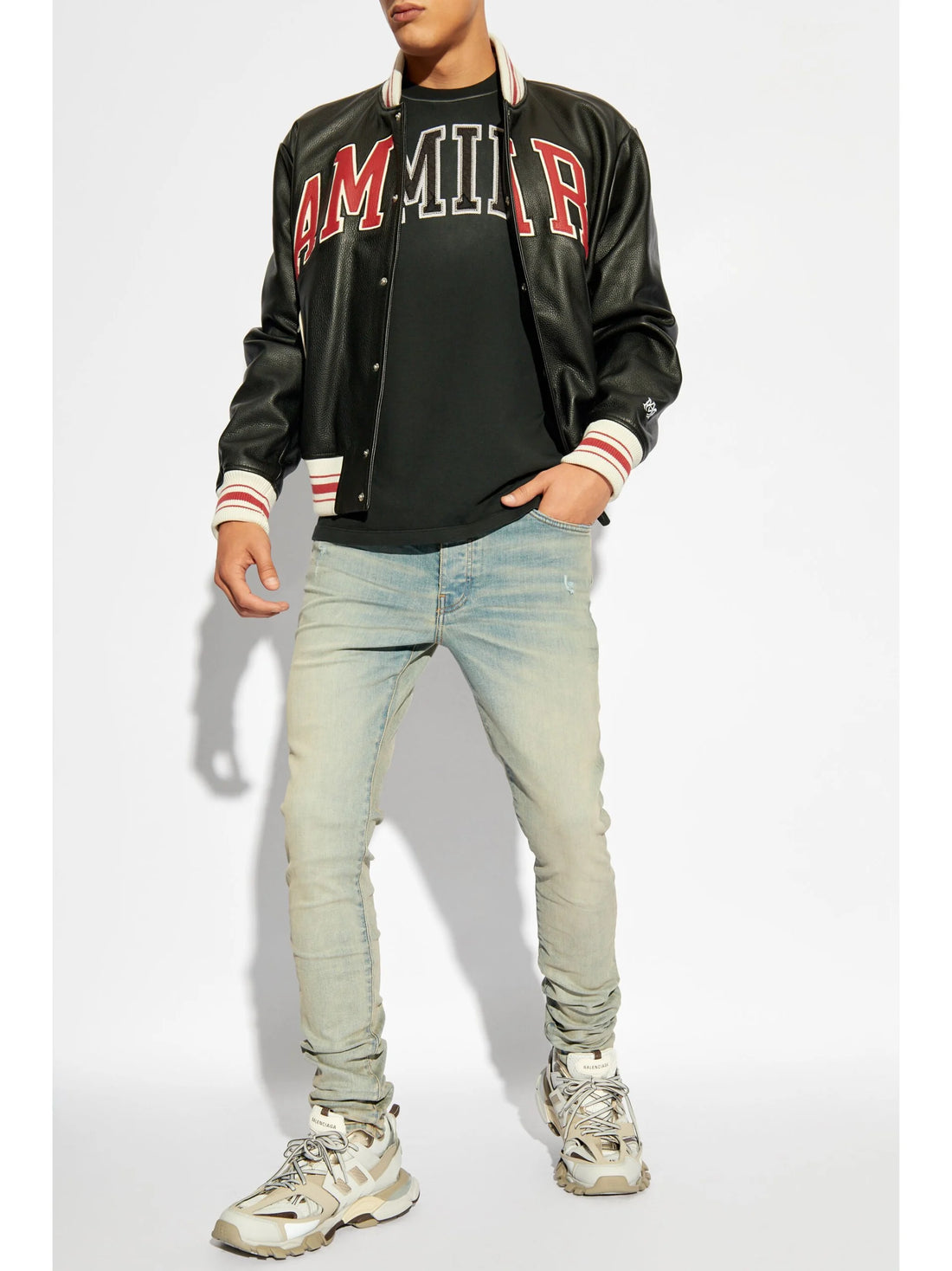A pair of light blue skinny jeans by AMIRI, available at Lestyle Boutique. These low-rise jeans feature a stretch construction, faded detailing, whiskering effects, and a classic five-pocket design for a stylish, comfortable fit.