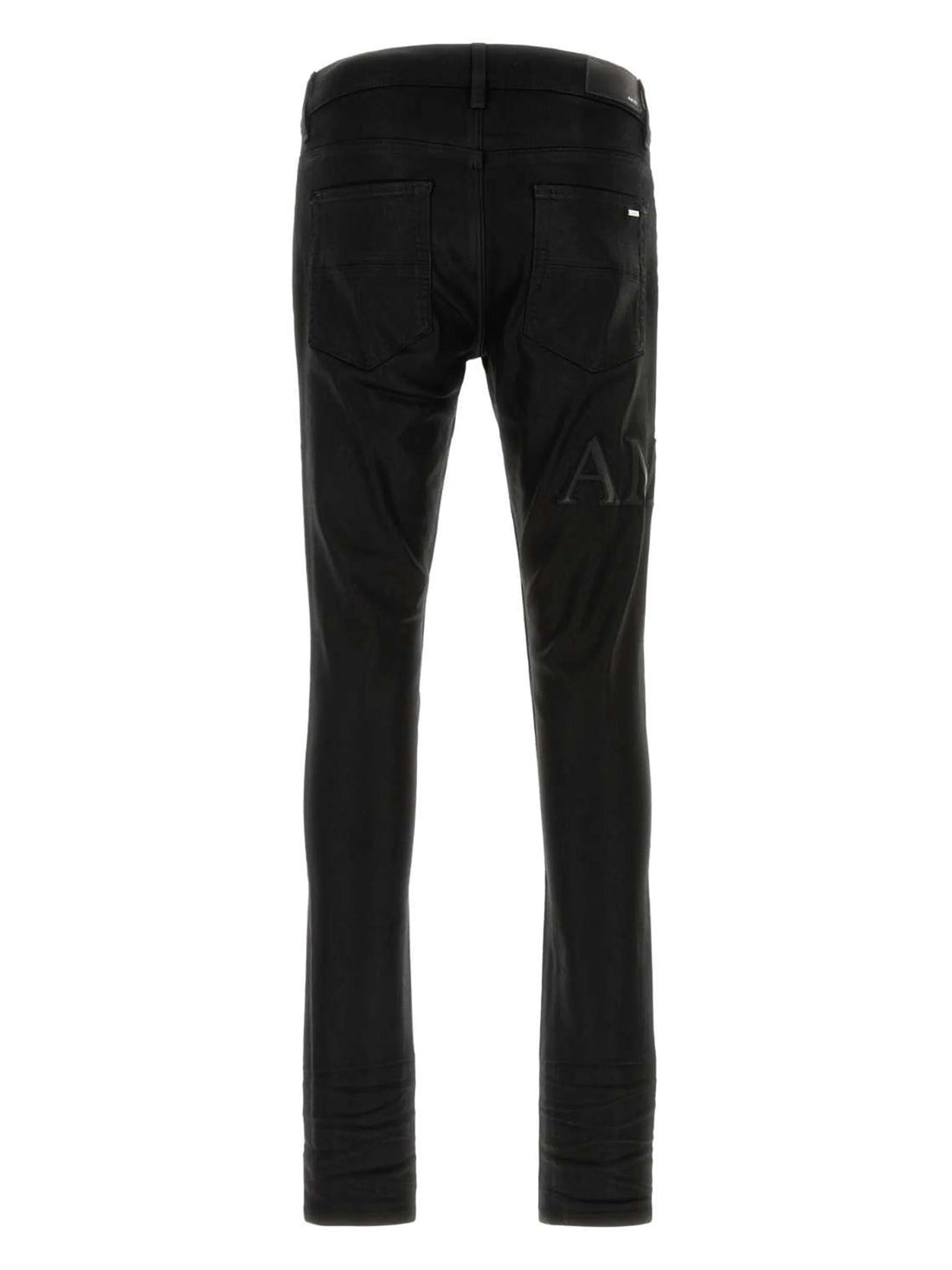 A pair of black stretch skinny jeans by AMIRI, available at Lestyle Boutique. These jeans feature a comfortable fit with a sleek design, button and zip closure, and classic five-pocket detailing.
