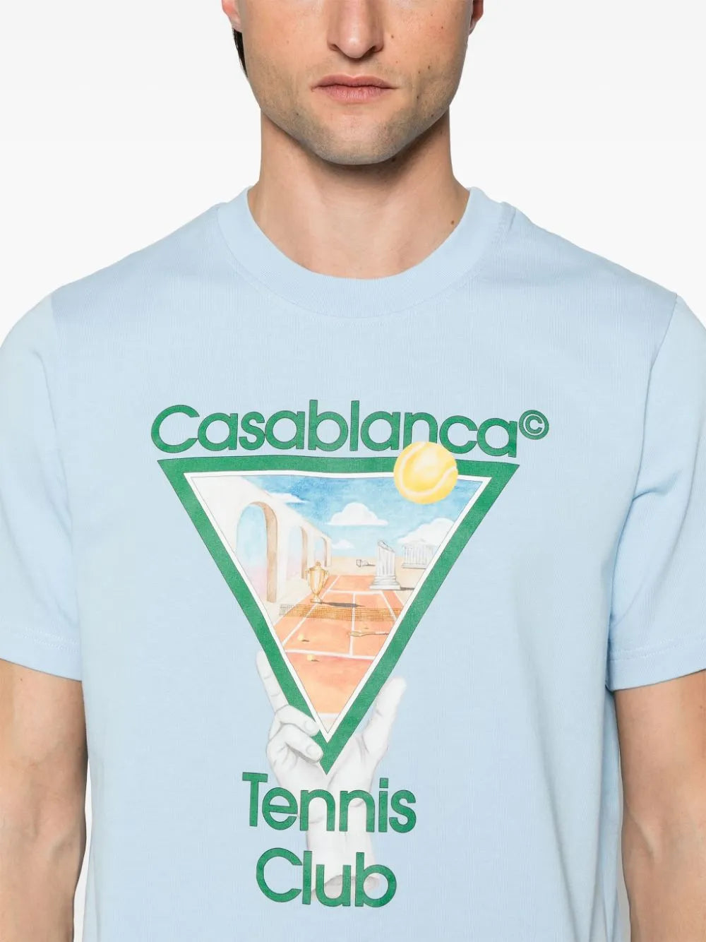 Casablanca Metaphysical Tennis Icon T-Shirt in Light Blue, crafted from 100% organic cotton, featuring a crew neck and a signature Tennis Club print on the front. Available at Lestyle Boutique.