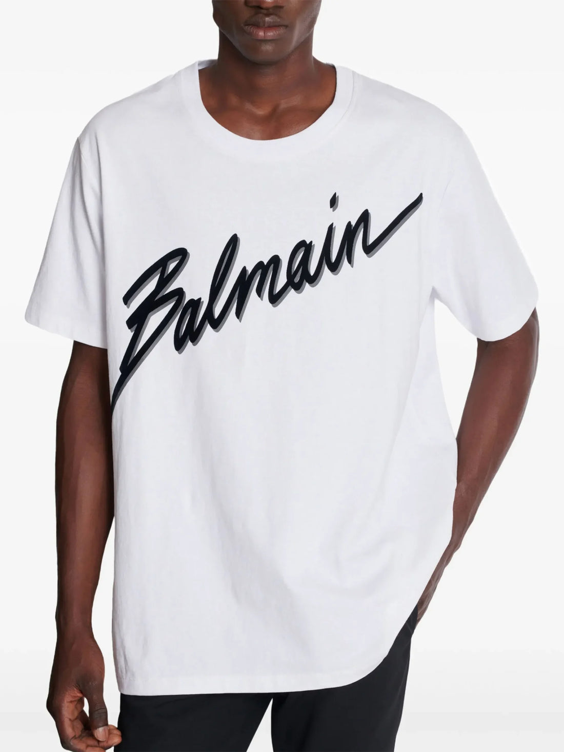 Balmain white cotton T-shirt featuring a bold logo print on the front, a crew neck, and short sleeves, available at Lestyle Boutique.