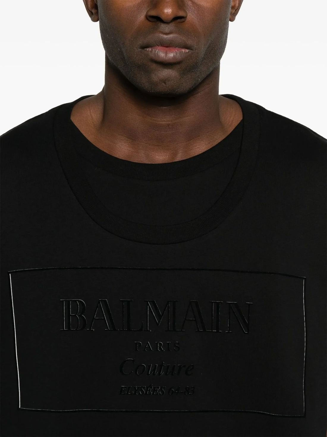 Balmain Black Flocked-Logo T-Shirt with a tonal embossed logo at the chest, crafted from premium cotton, available at Lestyle Boutique.