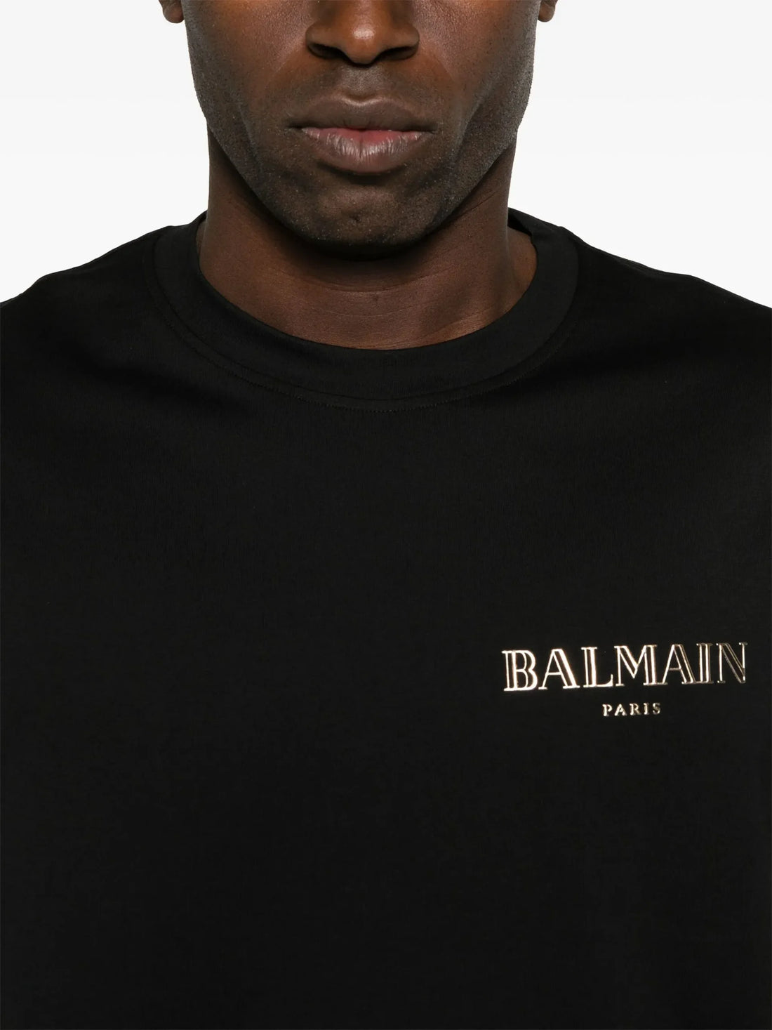 Balmain Black Logo-Appliqué T-Shirt with a minimalist chest logo, crafted from premium cotton, available at Lestyle Boutique.