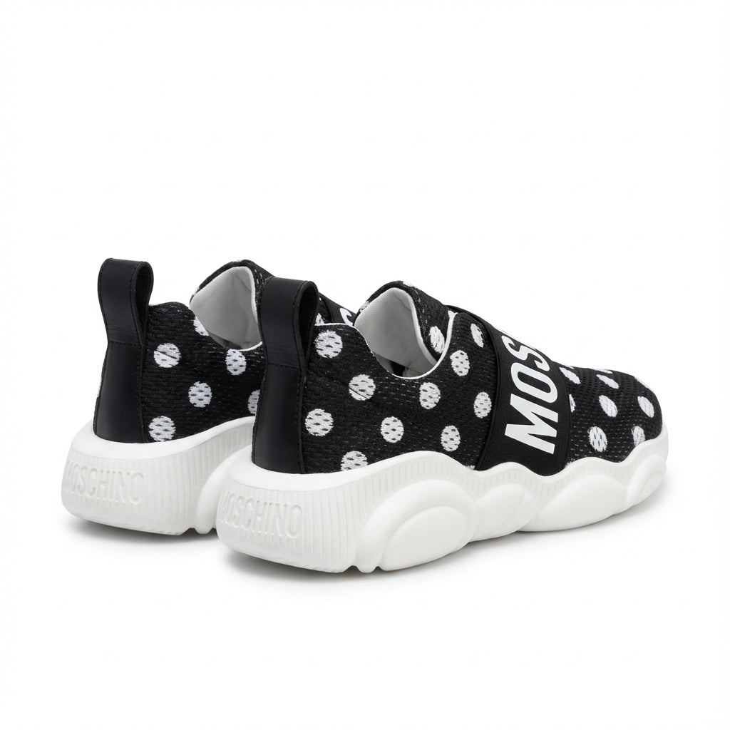 Moschino sneakers featuring a logo strap on a black knit upper with white polka dots, available at Lestyle Boutique Melbourne