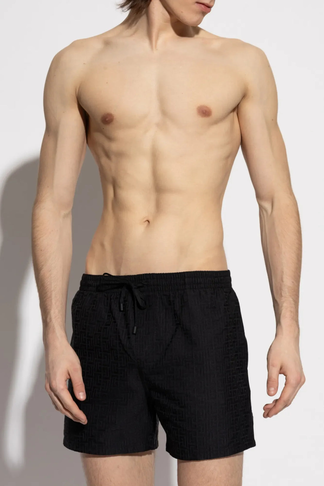 Balmain black swim shorts featuring a unique combination of classic cut and modern materials, ensuring comfort and elegance. Available at Lestyle Boutique Melbourne.