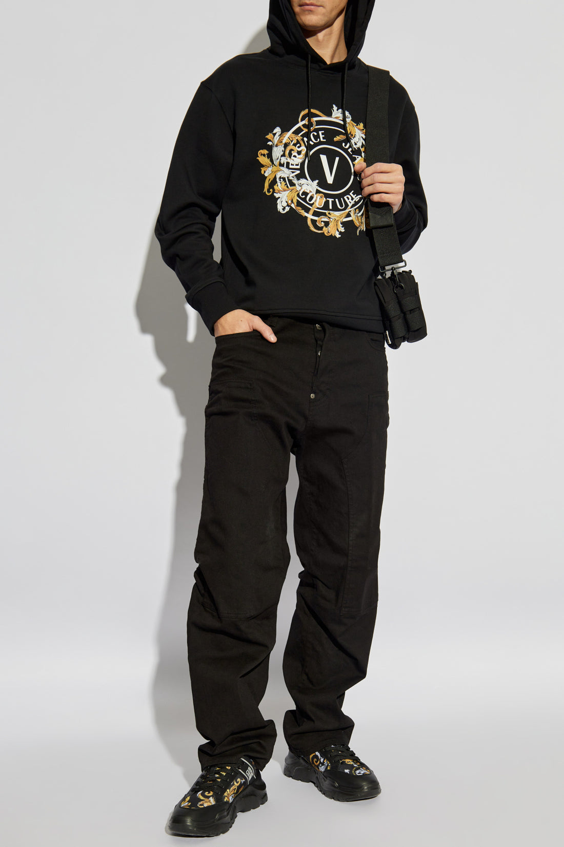 Versace Jeans Couture Black Hoodie featuring a Barocco-inspired "V" logo and crafted from premium cotton, perfect for an elegant yet casual look. Available now at Lestyle Boutique.