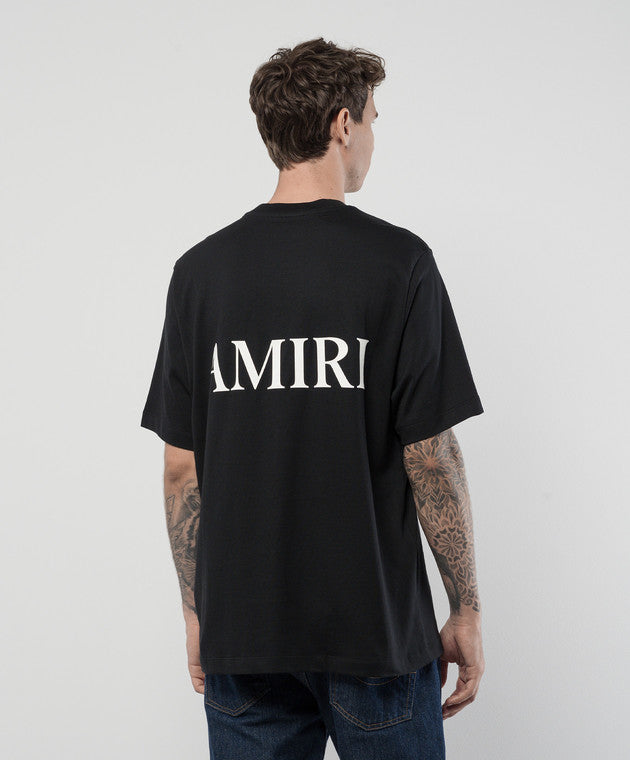 A black cotton t-shirt by AMIRI, available at Lestyle Boutique. Featuring the MA monogram logo on the chest and a bold AMIRI logo on the back, this tee offers a perfect blend of style and comfort.