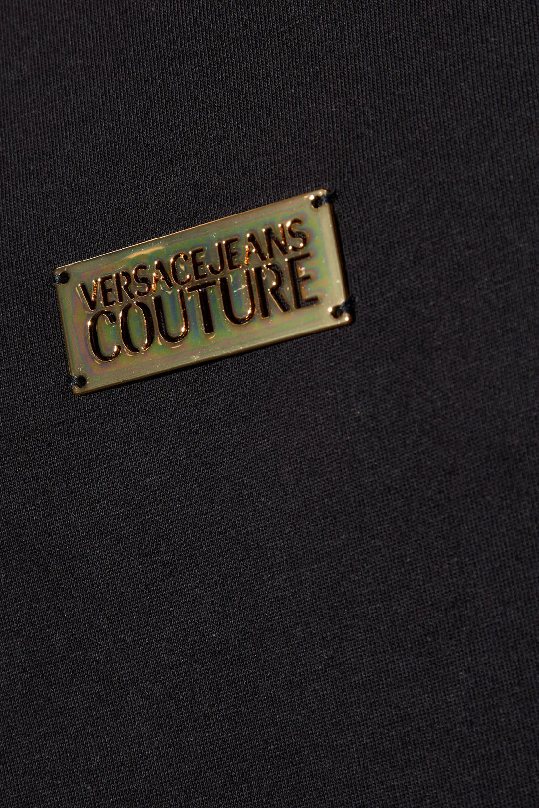 Versace Jeans Couture Metal Logo Plaque T-Shirt in black, featuring a crewneck design and signature metal logo plaque detail, combining comfort with designer aesthetics, available at Lestyle Boutique.
