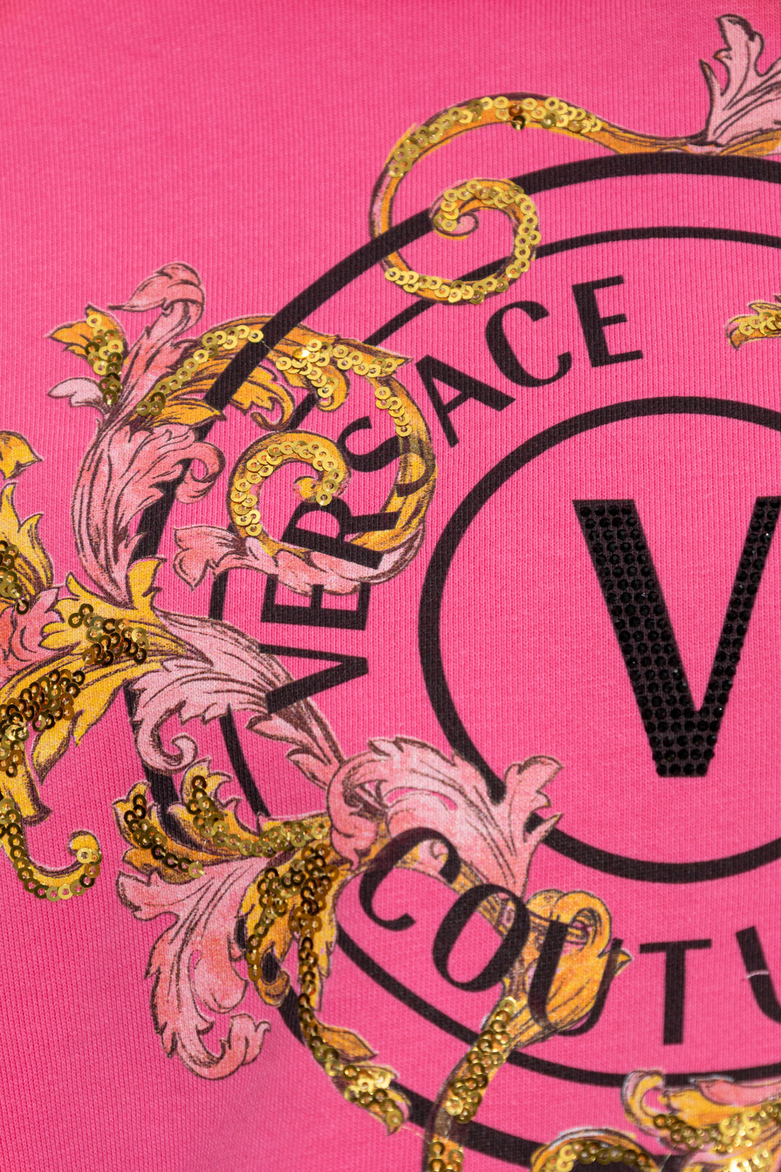 Versace Jeans Couture Pink Sweatshirt featuring a bold "V" logo print with gold sequins and floral details, available at Lestyle Boutique.