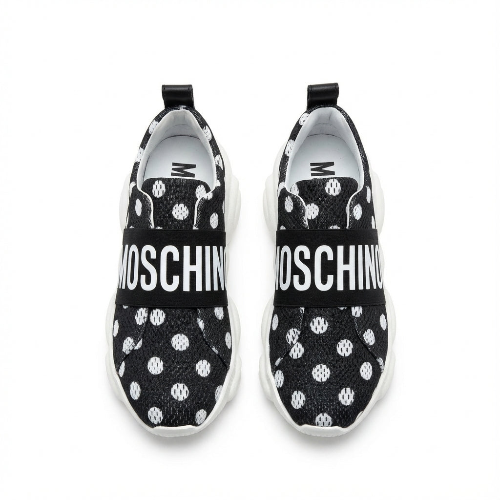 Moschino sneakers featuring a logo strap on a black knit upper with white polka dots, available at Lestyle Boutique Melbourne