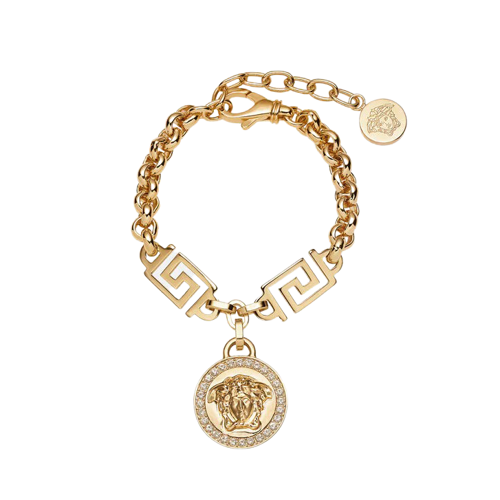Gold bracelet with a Medusa head charm on a white background