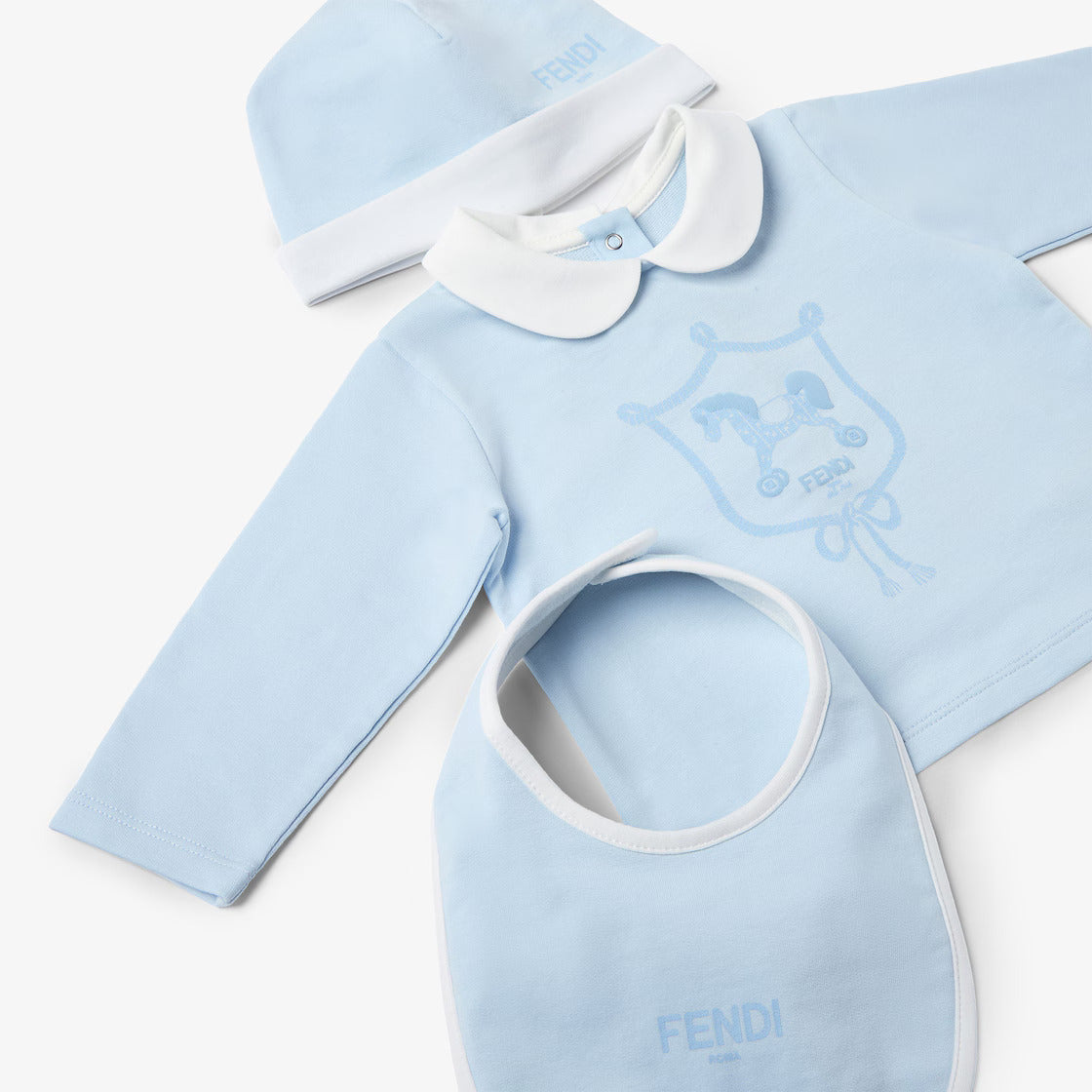 Baby clothing set with blue long-sleeve shirt, bib, and hat on a white background