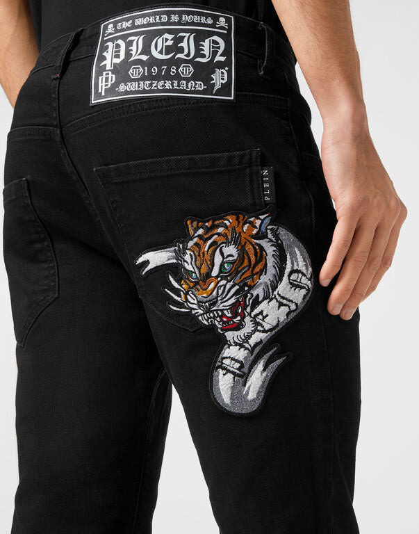 Philipp Plein black skinny-fit denim trousers with embroidered patch and stone-washed finish, available at Lestyle Boutique.